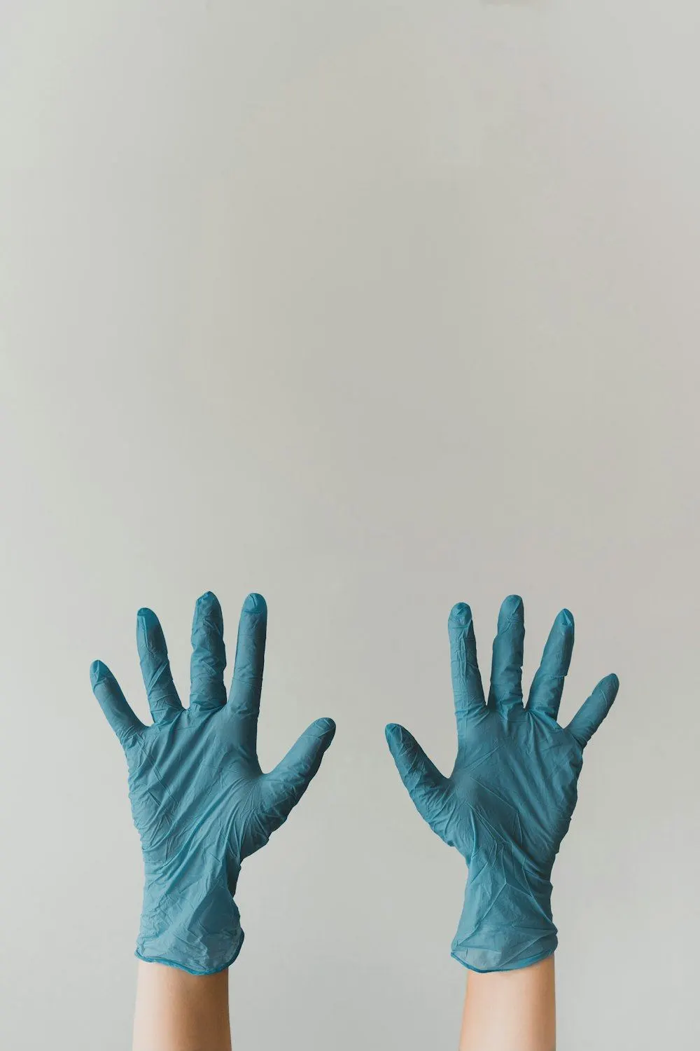 Manos con guantes de nitrilo azules